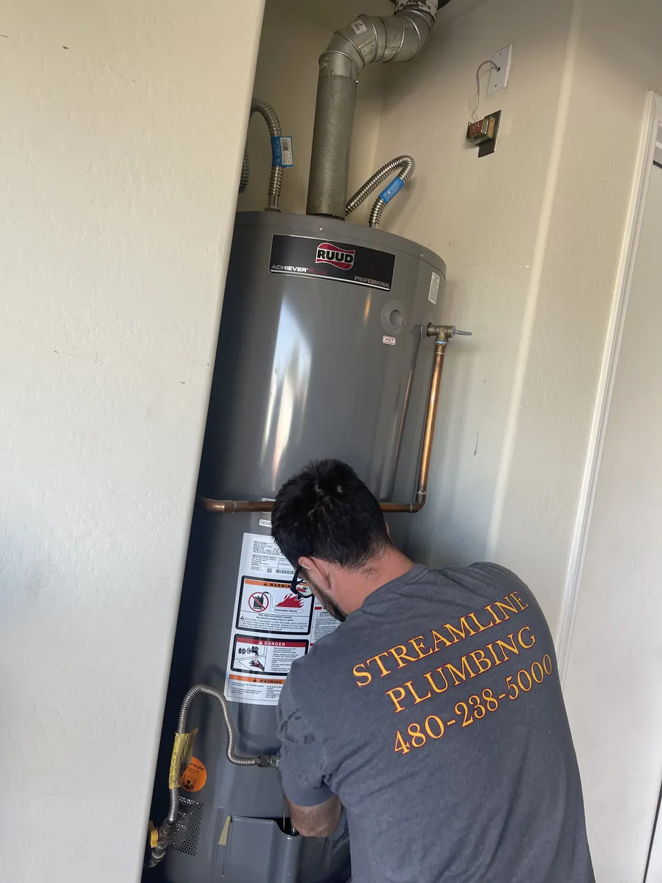 Streamline Plumbing AZ plumber installing a new tank water heater