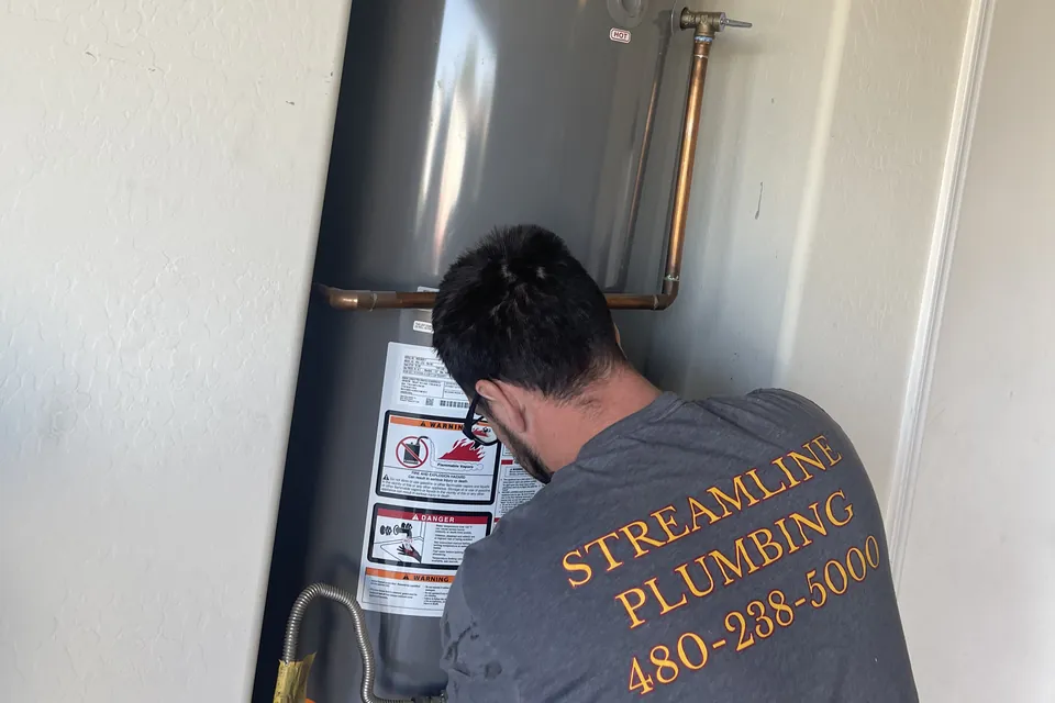 Streamline Plumbing AZ plumber connecting a new tank water heater