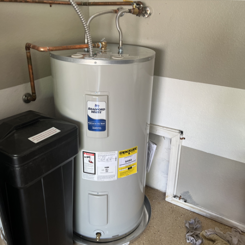 A standard tank water heater installed in a utility room.